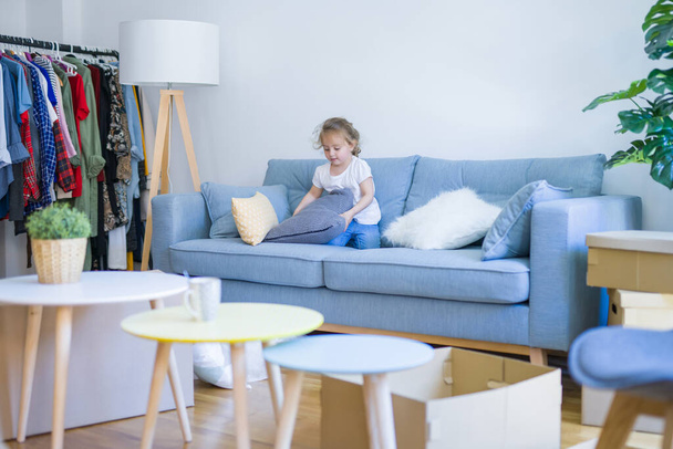 Beautiful toddler child girl jumping on the sofa - Photo, Image