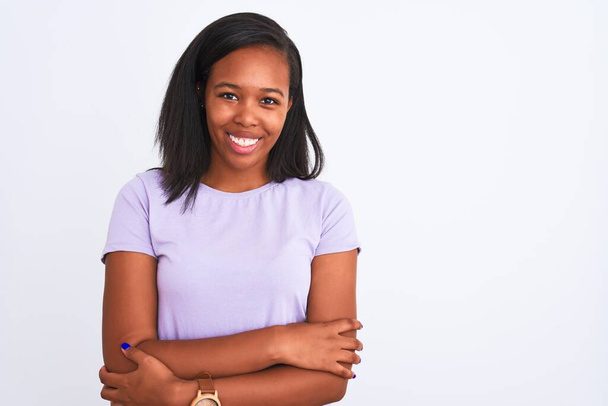 Beautiful young african american woman over isolated background happy face smiling with crossed arms looking at the camera. Positive person. - Photo, Image