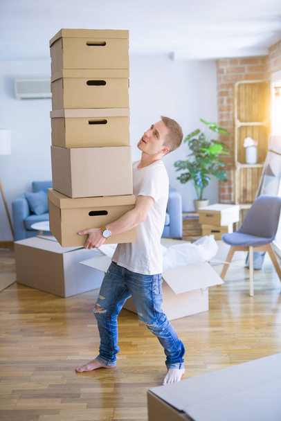 man with boxes moving to new house  - 写真・画像