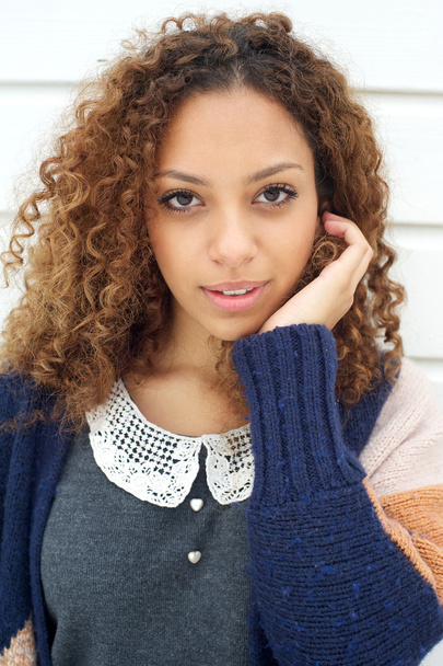 Portrait of an elegant young woman in sweater with hand in hair - Фото, зображення