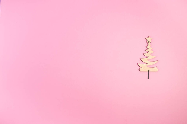 Cute Christmas tree is made of wood. Minimal Christmas or New Year concept. - Photo, image