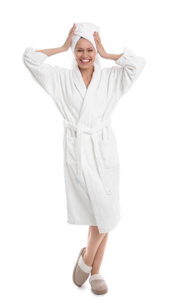 Young woman in bathrobe on white background - Zdjęcie, obraz