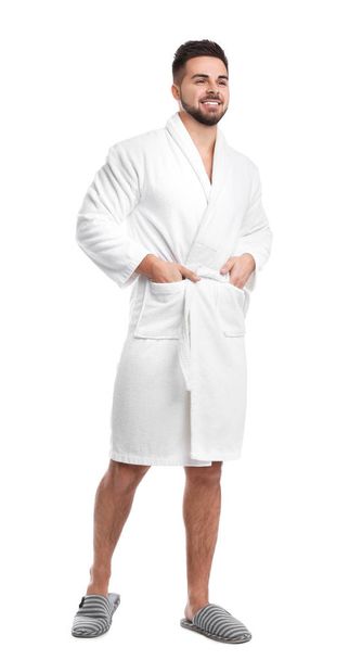 Handsome man wearing bathrobe on white background - Foto, imagen