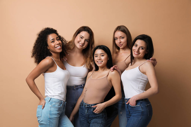 Group of women with different body types on beige background - Photo, Image