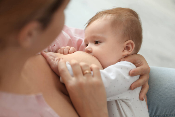Young woman breastfeeding her baby at home, closeup - Φωτογραφία, εικόνα