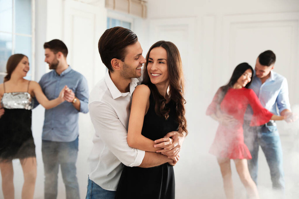 Lovely young couple dancing together at party - Фото, изображение