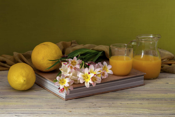 Still life with freesia, lemons and orange juice - Photo, Image