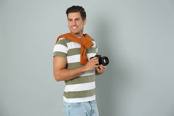 Professional photographer working on light grey background in st - Photo, image