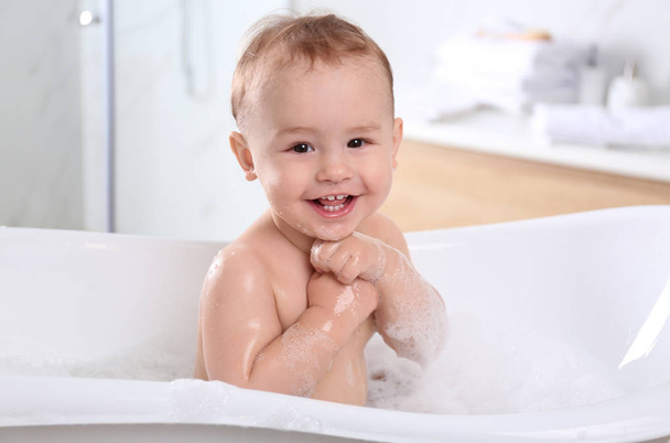 Cute little baby in bathtub at home - Foto, Imagem