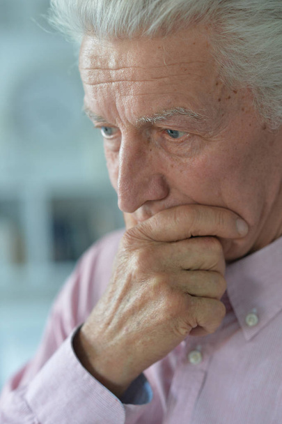 Close up portrait of thoughtful senior man at home - Фото, изображение