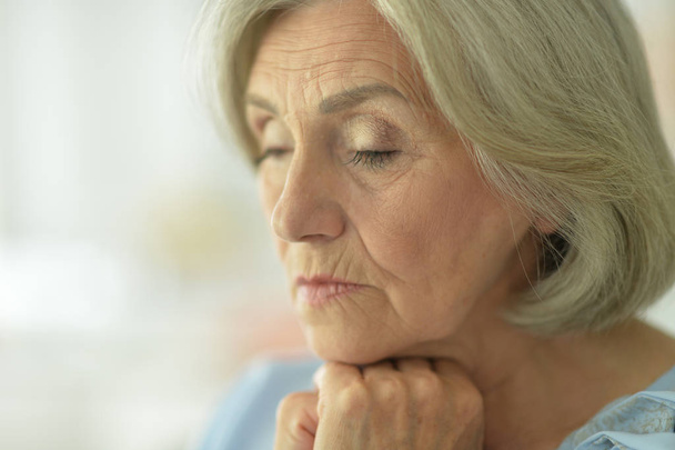 Close up portrait of sad senior woman at home  - Fotografie, Obrázek