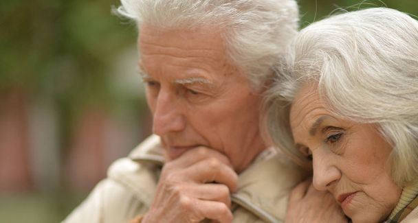 Sad thoughtful senior couple in  park - Фото, зображення