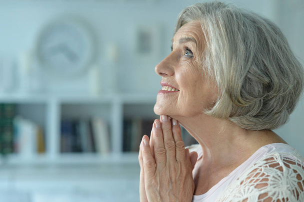 Portrait of beautiful  senior woman praying - Foto, imagen