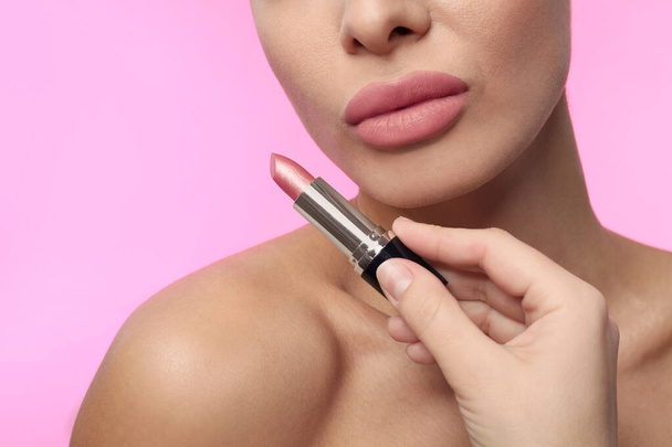 Woman with matte lipstick on pink background, closeup - Photo, image