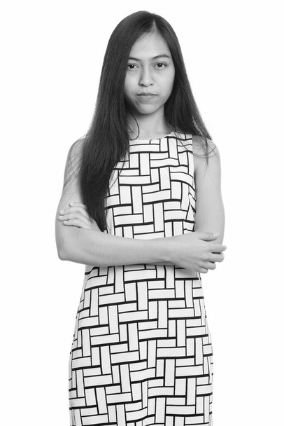 Studio shot of young Asian teenage girl standing with arms crossed - Fotografie, Obrázek