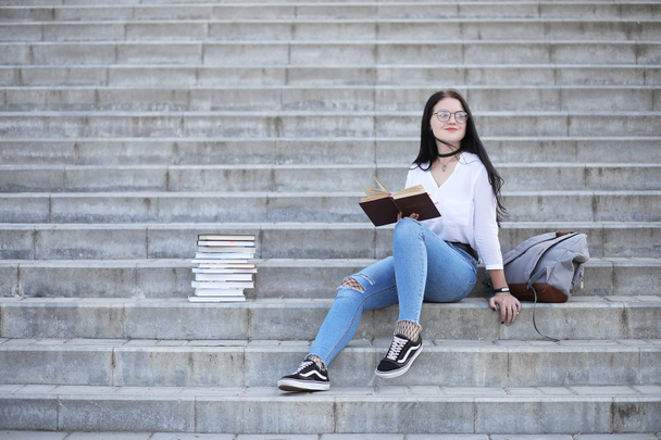 Girl student on the street with books - Fotoğraf, Görsel
