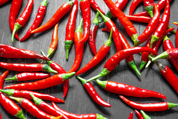 Red hot peppers on wooden background - Foto, afbeelding