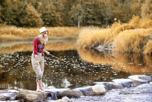 Chica en otoño con una caña de pescar
 - Foto, imagen
