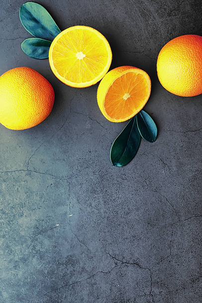 Orange citrus fruit on a stone table. Orange background. - Фото, зображення