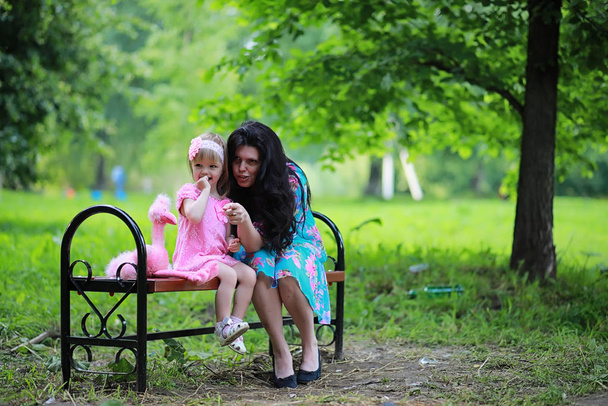 Mom with cute daughter on a walk in the park - Valokuva, kuva