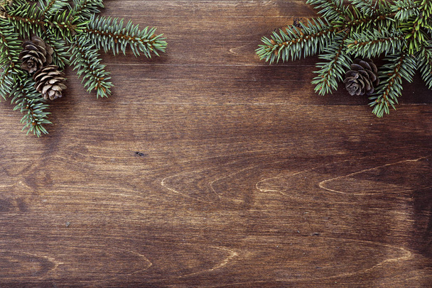 New Year's background. Spruce branches on a wooden table. Orname - Fotografie, Obrázek