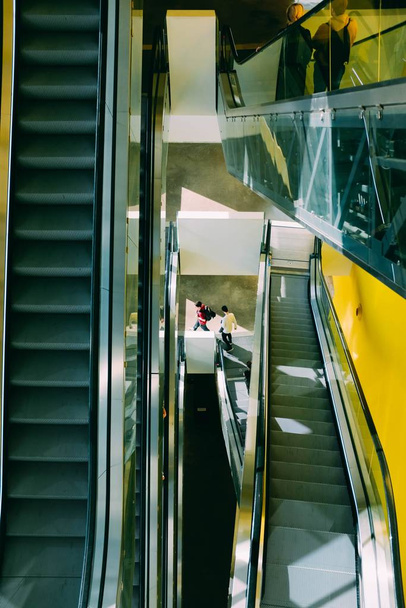 Vertical high angle shot of the escalators in a mall - Fotó, kép