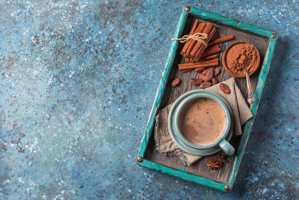 Tasty cocoa drink with spices in big cozy cup - Фото, изображение