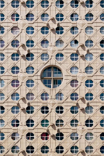 Vertical shot of beautiful windows on a brown high rise building - Photo, Image