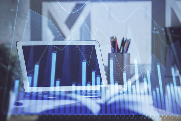 Stock market graph on background with desk and personal computer. Multi exposure. Concept of financial analysis. - Foto, Bild
