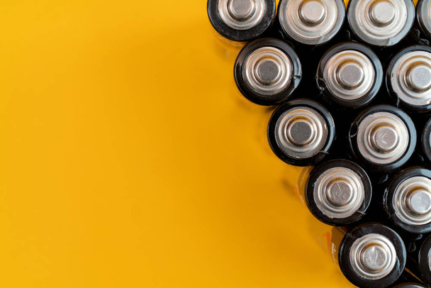 Used batteries are arranged in a triangle shape. Recycling and d - Foto, immagini