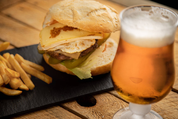 Cheeseburger with potatoes and beer - Фото, изображение