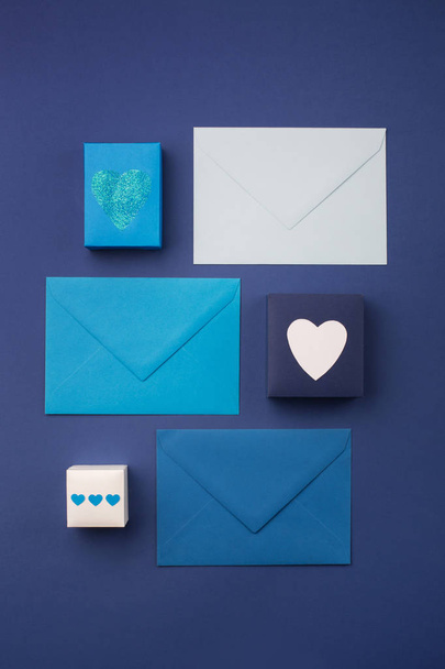 Blue envelopes, gifts and white hearts on classic blue  - Zdjęcie, obraz