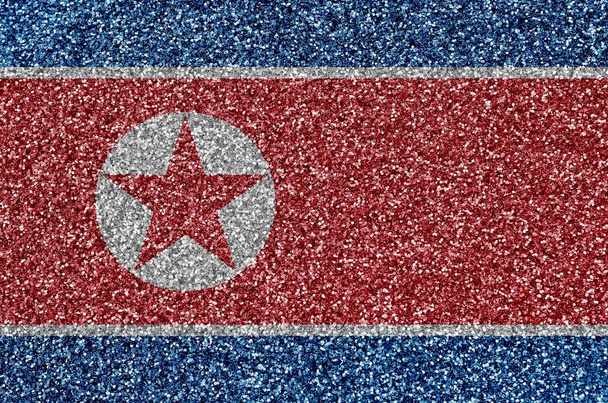Az észak-koreai zászló sok apró csillogó flitteren látható. Színes fesztivál háttér disco party - Fotó, kép