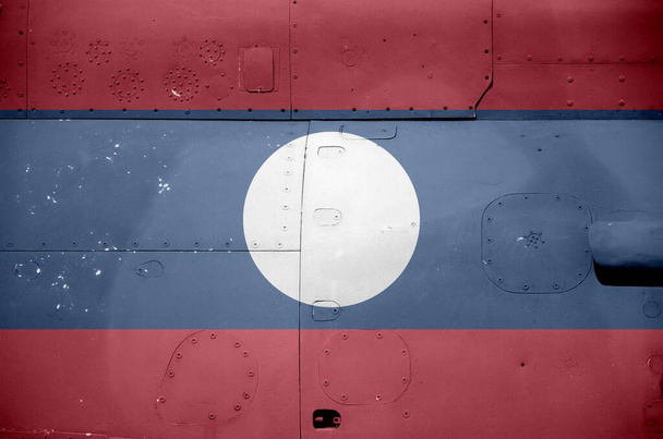 Laos flag depicted on side part of military armored helicopter close up. Army forces aircraft conceptual background - Photo, Image