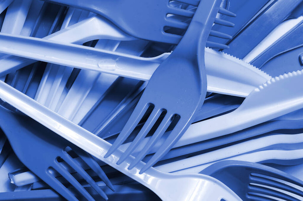 Pile of phantom classic blue color used plastic kitchenware appliances. Ecological problem. Plastic pollution - Fotoğraf, Görsel