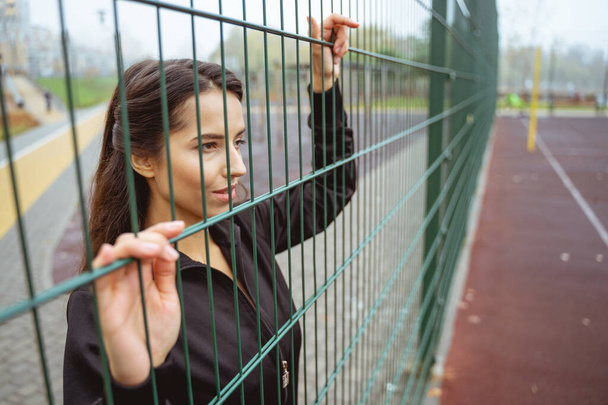 Concentrated female person looking at sports area - 写真・画像