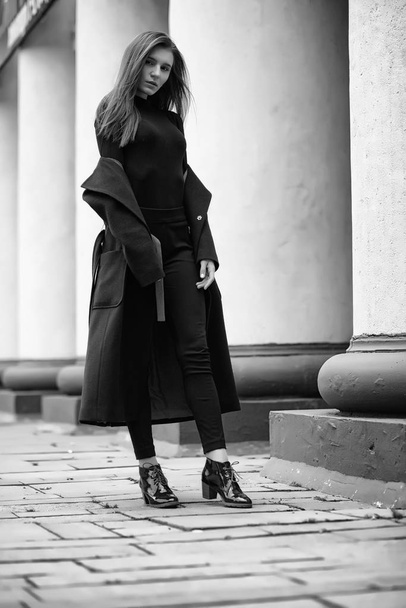 Girl in a coat black and white photo - Фото, зображення
