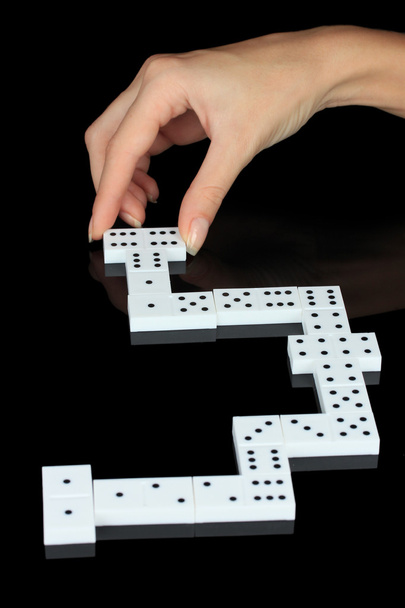 Hand playing domino isolated on black - Fotoğraf, Görsel