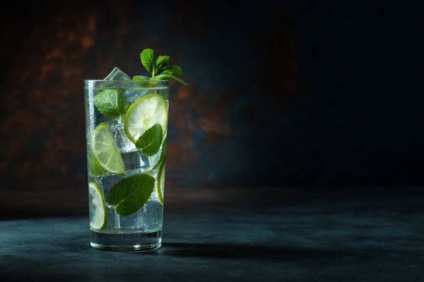 Mojito cocktail on black background with lime and mint with copy space - Foto, imagen