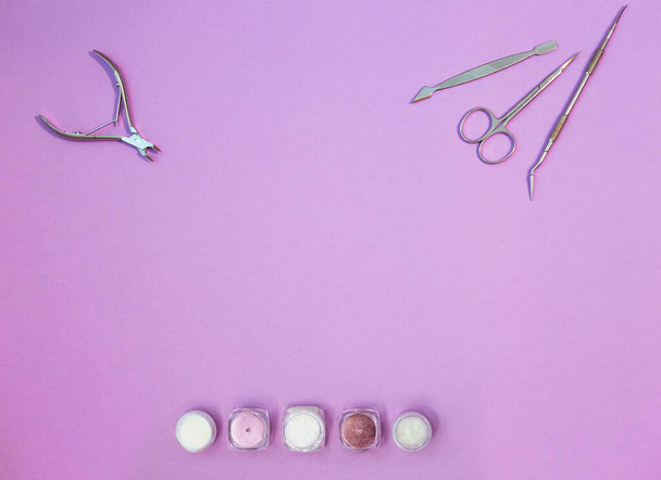 Top view of manicure and pedicure equipment on pink background - 写真・画像