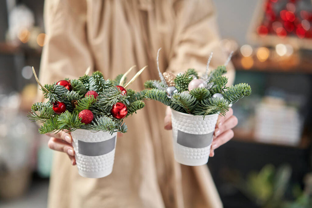 zwei schöne festliche Arrangements aus frischer Fichte in Kaffeetasse. Weihnachtsstimmung. - Foto, Bild