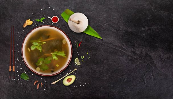 Miso soup Japanese food background with various ingredients on stone background. - 写真・画像