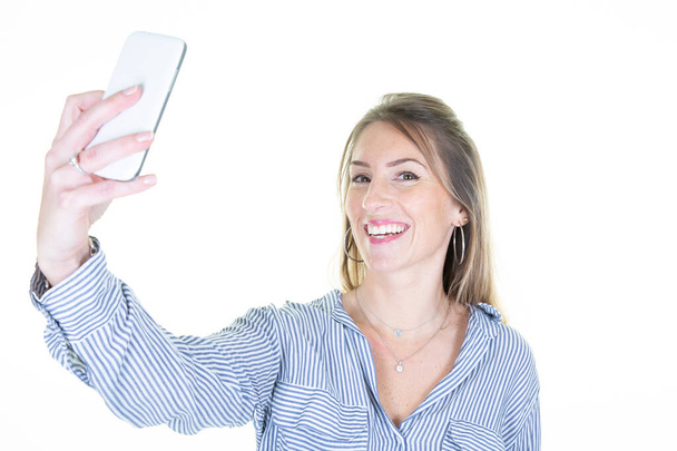 Pretty blonde happy young woman making selfie on white background - Photo, Image
