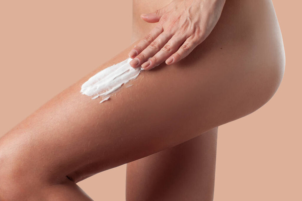 Body care. Woman applying anti cellulite cream on legs. - 写真・画像