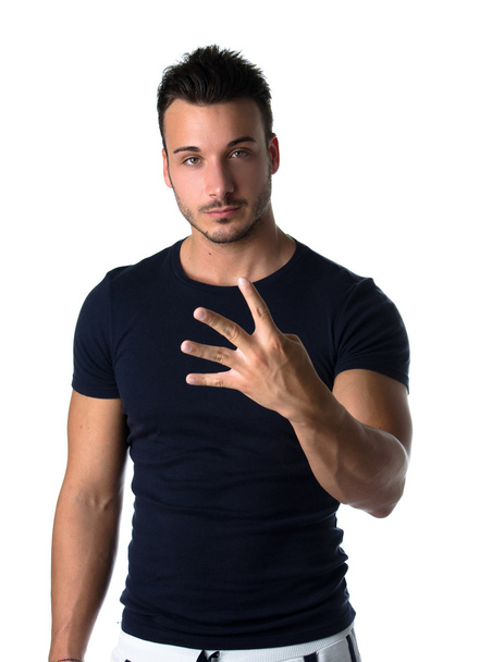 Handsome young man counting to four with fingers and hands - Foto, afbeelding