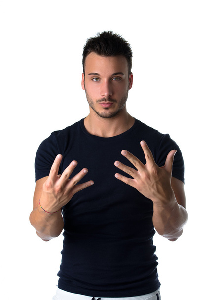 Handsome young man counting to nine with fingers and hands - Foto, immagini