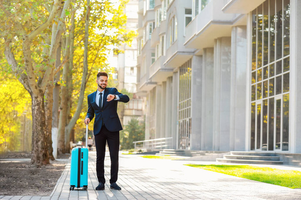 Young man with luggage for business trip outdoors - Photo, Image