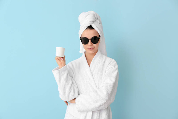 Beautiful young woman after shower drinking coffee on color background - Foto, Bild