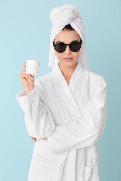 Beautiful young woman after shower drinking coffee on color background - Fotoğraf, Görsel