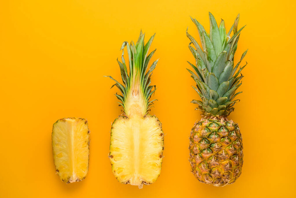 Fresh ripe pineapples on color background - Φωτογραφία, εικόνα